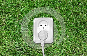 Electric outlet on green grass