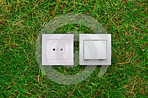 Electric outlet and light switch on a grass