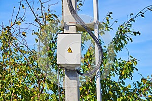 Electric panel on the grey concrete pillar