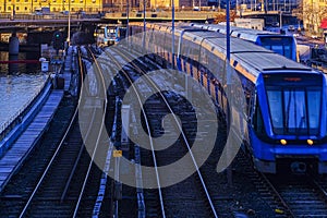 Electric passenger train on the metro bridge across the river