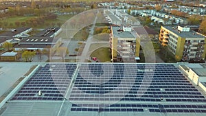 Electric photovoltaic solar panels installed on shopping mall building rooftop for production of green ecological