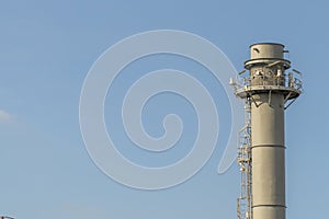 Electric plant chimney against the blue sky background, Power plant flue