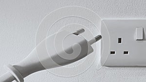 Electric plug connected to wall socket