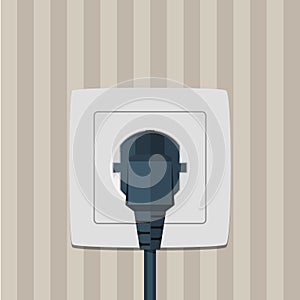 Electric plug and socket on a wall.