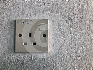Electric plug socket on white wall. Selective focus