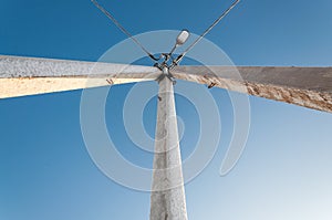 Electric pole on blue sky background during sunrise