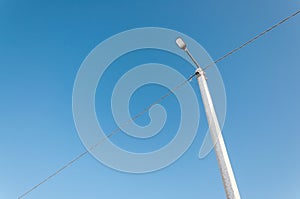 Electric pole on blue sky background during sunrise