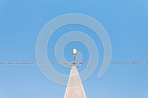 Electric pole on blue sky background during sunrise