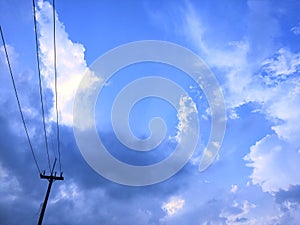 Electric pole, blue sky and white clouds.