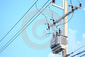 Electric pole and electric transformer on sky background.