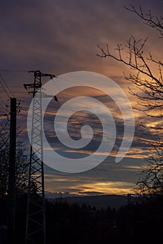 Electric pole in a field during the sunset