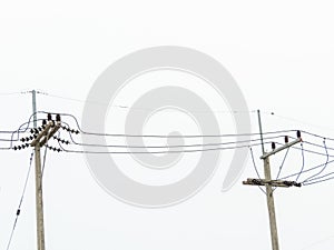 The electric pole stood tall along the roadside,