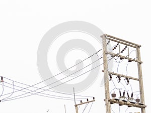 The electric pole stood tall along the roadside, its wires stretching out like intricate veins,