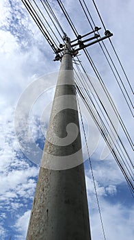 electric pole with a stretch of electric cable. electrical installation. electronic cable. power lines between trees