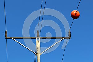 Electric pole and wire against the blue sky