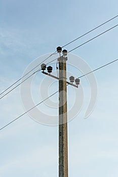 Electric pole with wires against the sky