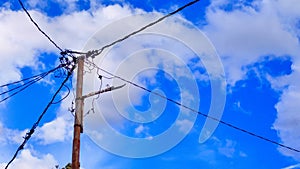 The electric poles and blue sky background