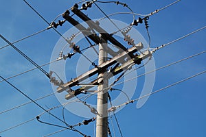 Electric post with hanging wires powering up homes and offices