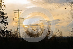 Electric powelines over nature with sunset