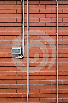 Electric power meter on the brick wall