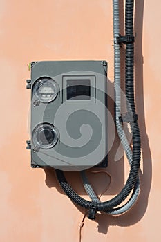 Electric power meter outdoor. House Watt hour Electric meter measurement on house wall.