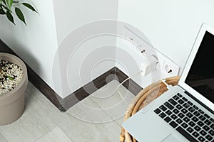 Electric power outlet sockets with charger on white wall