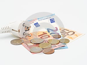 Electric power plug and Euro money on white background