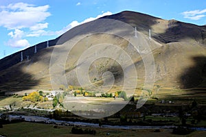 Electric power pylons on Tibetan mountains