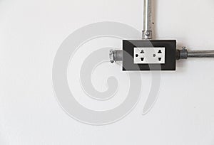 Electric power socket on white wall