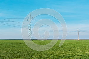 Electric power transmission, electricity power line pylons in countryside fields