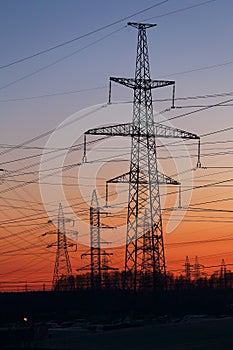 Electric power transmission lines at sunset.