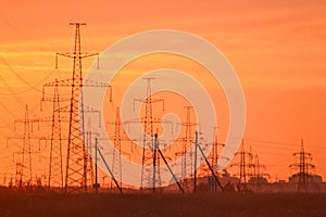 Electric power transmission lines at sunset