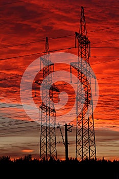 Electric power transmission lines at sunset.