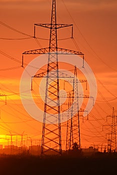 Electric power transmission lines at sunset.