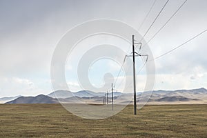 Electric power transmission pylons on grassland