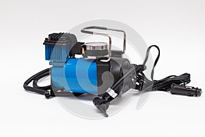 Electric pump inflates for a car wheel. Car auto air compressor isolated on the white background