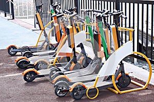 Electric push scooters for rent in parking