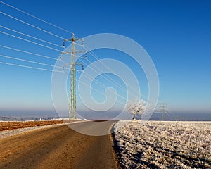 Electric pylon in landscape. High voltage power lines.