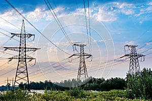 The electric pylon in the rice field with the blue sky. Energy distribution concept