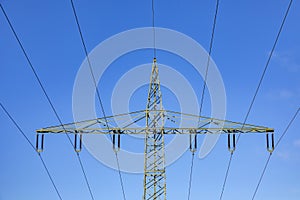 Electric pylon under blue sky