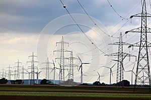 Electric pylons and wind farm photo