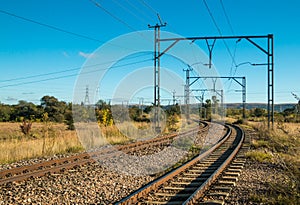 Electric railway lines going through a rural landscape