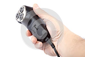 Electric razor in hand on white background