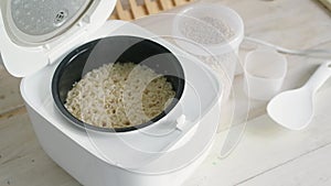 Electric rice cooker on wooden counter-top