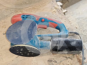 Electric sander in dust after work
