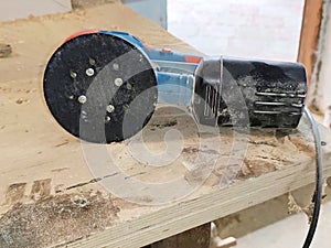 Electric sander in dust after work