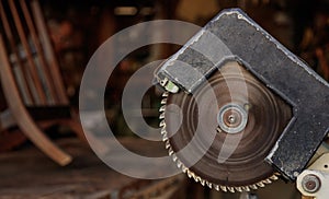 Electric saw old from steel with circular jagged disc for woodwork. Blur background, closeup, banner