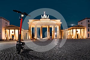 Electric scooter in the city for rent, Brandenburg Gate, Berlin, Germany