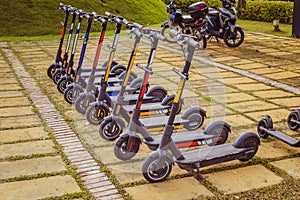 An electric scooter in a row at the park. Vintage image