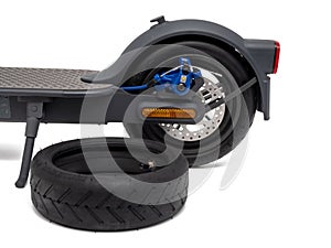 Electric scooter and spare wheel isolated on white background.